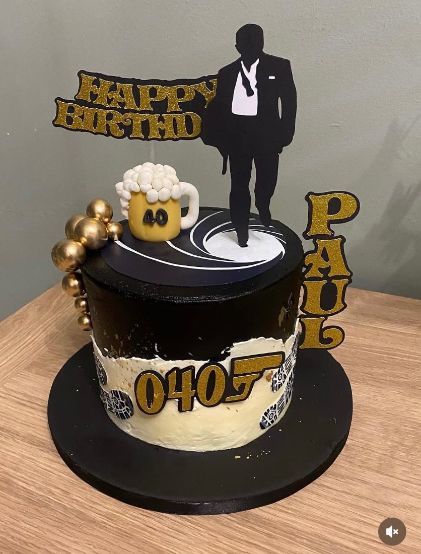 Black and gold 40th birthday cake with a silhouette topper